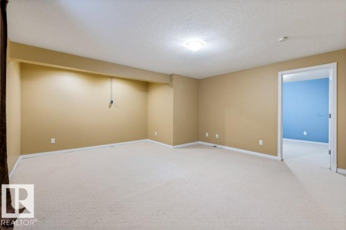 Expansive room featuring neutral beige wall paint and light-colored carpeting - 1119 Potter Greens, Edmonton, AB - Indoor Photo Showing Other Room