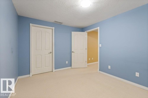 Carpeted room featuring light blue walls and white trim - 1119 Potter Greens, Edmonton, AB - Indoor Photo Showing Other Room