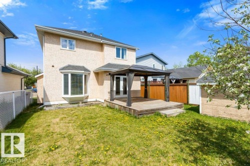 Rear exterior featuring a spacious wood deck with a gazebo, a bay window, a stucco finish, a detached storage shed, and a fenced perimeter - 1119 Potter Greens, Edmonton, AB - Outdoor With Exterior