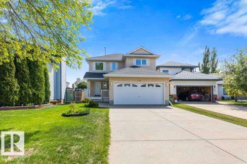 Two-story residence featuring a neutral stucco exterior and white trim accents - 1119 Potter Greens, Edmonton, AB - Outdoor With Facade