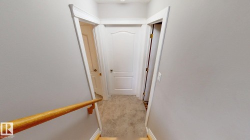 Carpeted hallway with light gray walls and white trim - 3738 28A Street, Edmonton, AB 
