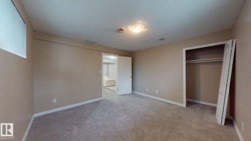 Carpeted room with neutral wall tones and white baseboards - 3738 28A Street, Edmonton, AB 