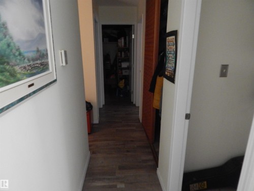 Hallway featuring wood-look flooring and white wall finishes - 204 4601 131 Avenue, Edmonton, AB 