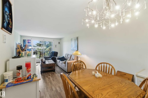 Open-concept living and dining area featuring wood-finish flooring - 204 4601 131 Avenue, Edmonton, AB 
