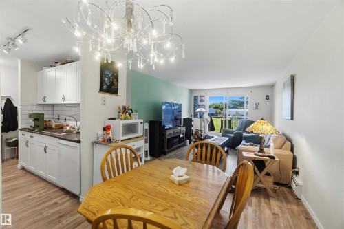 Open-concept living space with wood-finish flooring throughout - 204 4601 131 Avenue, Edmonton, AB 