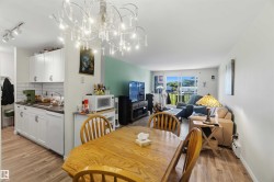 Open-concept living space with wood-finish flooring throughout - 