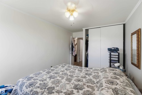 Room featuring a ceiling fan with light fixture, white walls, and crown molding - 204 4601 131 Avenue, Edmonton, AB 