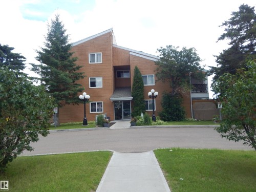 Multi-story building featuring warm brown siding and white-framed windows - 204 4601 131 Avenue, Edmonton, AB 