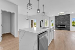Kitchen island featuring an undermount sink, matte black faucet, and integrated stainless steel dishwasher - 