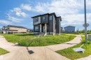 Contemporary architecture featuring dark gray siding with contrasting light gray accents - 292 Fraser Way Nw, Edmonton, AB 