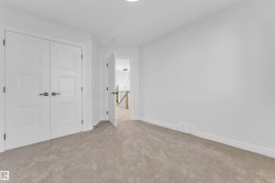 Light gray carpeting with white baseboards throughout - 