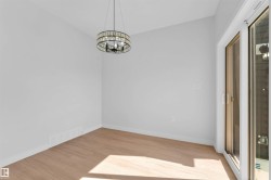 Light wood-finish flooring complements the neutral wall tones - 