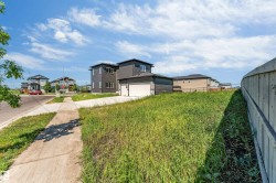 Contemporary property with dark grey siding, white trim windows, and an attached two-car garage - 