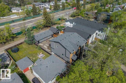 Modern residential property featuring a multi-level design and dark shingled roof - 10932 132 Street, Edmonton, AB - Outdoor With View