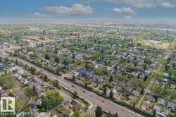 Aerial perspective highlighting a residential area with varied architectural styles and mature tree cover - 