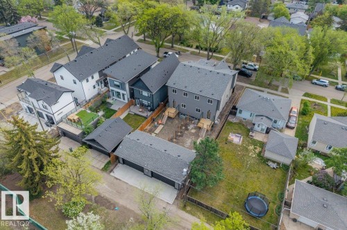 Aerial perspective showcasing multiple properties, featuring grey shingle roofs and various exterior finishes - 10932 132 Street, Edmonton, AB - Outdoor With View