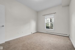 Neutral wall paint with baseboard trim, carpet flooring, single window with blinds, and a white door with a chrome handle - 