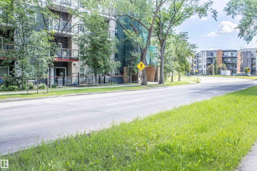 Contemporary multi-story building featuring balconies with glass railings - #209 10611 117 St Nw, Edmonton, AB 