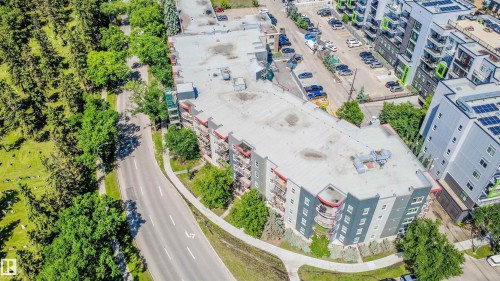 Multi-story building with a flat roof and a contemporary exterior featuring balconies - #209 10611 117 St Nw, Edmonton, AB 