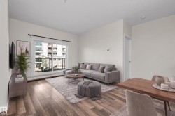 Open concept living area with wood-finish flooring - 