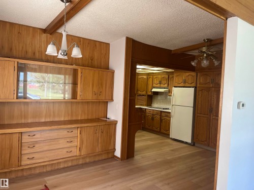 Built-in cabinetry and display shelving with glass fronts - 8736 72 Street Nw, Edmonton, AB - Indoor Photo Showing Kitchen