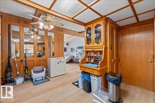 Wood-finish flooring throughout - 8736 72 Street Nw, Edmonton, AB - Indoor Photo Showing Other Room