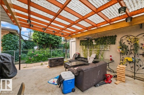Covered patio space featuring a translucent corrugated roof and exposed wood beams - 8736 72 Street Nw, Edmonton, AB - Outdoor With Deck Patio Veranda