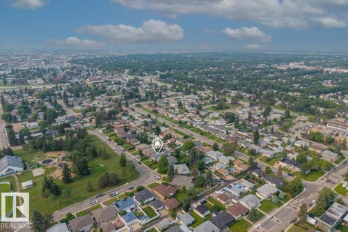 Residential property situated on a corner lot, surrounded by mature trees and paved streets - 8736 72 Street Nw, Edmonton, AB - Outdoor With View