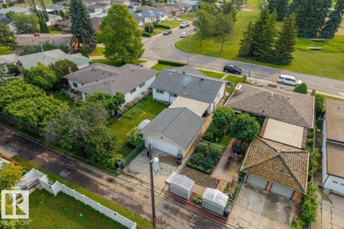 Aerial perspective showcasing a residential property with a detached garage and a paved driveway - 8736 72 Street Nw, Edmonton, AB - Outdoor With View