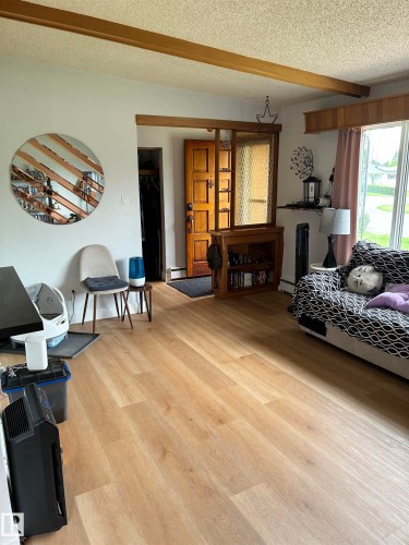 Light wood-finish flooring extending throughout the space - 8736 72 Street Nw, Edmonton, AB - Indoor