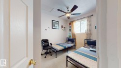 Room featuring a ceiling fan with light fixture, window with blinds, and light-colored walls - 