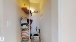 Recessed closet featuring white wire shelving, a wall-mounted coat rack, and light-toned wall finishes - 