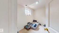 Carpeted room with a single window, white walls, and a flush-mount ceiling light - 