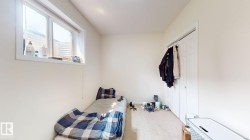 Room featuring light-colored walls and neutral carpet flooring - 