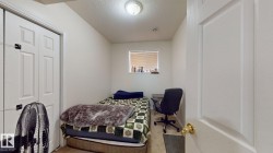 Compact room featuring a single window, white walls, and a ceiling-mounted light fixture - 