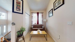 Bright interior space featuring a window with blinds and curtains, neutral wall paint, bi-fold closet doors, and carpet flooring - 