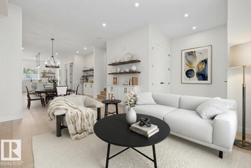 Bright living area featuring wood-finish flooring, recessed lighting, and white walls - 10934 132 Street, Edmonton, AB - Indoor Photo Showing Living Room