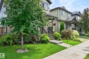 Two-story residence featuring light green siding and dark trim accents - 33 Durrand Bend, Fort Saskatchewan, AB 