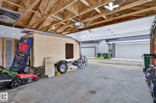 Exposed ceiling joists with unfinished plywood decking and fluorescent lighting - 33 Durrand Bend, Fort Saskatchewan, AB 