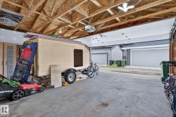 Exposed ceiling joists with unfinished plywood decking and fluorescent lighting - 