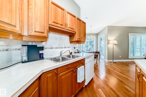 Kitchen featuring light wood-finish cabinetry, a double basin stainless steel sink, and white countertops - 29 929 Picard Drive, Edmonton, AB - Indoor Photo Showing Kitchen With Double Sink