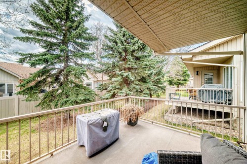 Spacious concrete patio featuring a metal railing and an overhead awning - 29 929 Picard Drive, Edmonton, AB - Outdoor With Deck Patio Veranda With Exterior