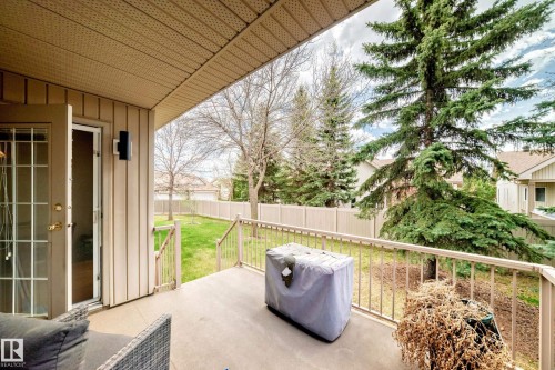 Covered patio featuring a solid ceiling, exterior wall sconce, and access through double French doors - 29 929 Picard Drive, Edmonton, AB - Outdoor With Deck Patio Veranda