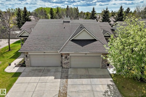 Two-unit property with stone accent columns, asphalt shingle roofing, and concrete driveways - 29 929 Picard Drive, Edmonton, AB - Outdoor