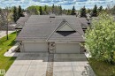 Two-unit property with stone accent columns, asphalt shingle roofing, and concrete driveways - 29 929 Picard Drive, Edmonton, AB  - Outdoor 