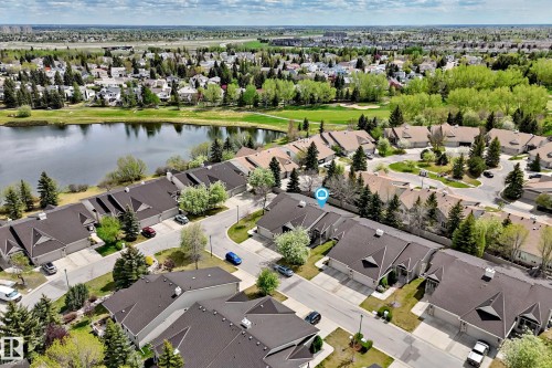 Aerial perspective of a residential community featuring a lakefront setting - 29 929 Picard Drive, Edmonton, AB - Outdoor With Body Of Water With View