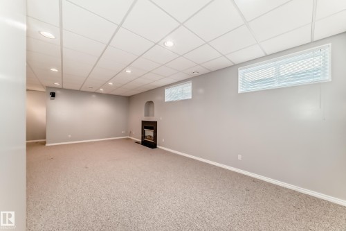 Spacious room featuring light-colored carpeting, a drop ceiling with recessed lighting, and light gray wall paint - 29 929 Picard Drive, Edmonton, AB - Indoor Photo Showing Basement