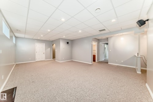 Spacious carpeted room featuring a drop ceiling with recessed lighting, light gray painted walls, and white trim - 29 929 Picard Drive, Edmonton, AB - Indoor