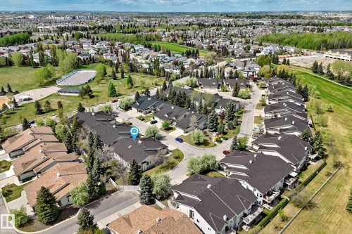 Aerial perspective showcasing a residential community with abundant green spaces - 29 929 Picard Drive, Edmonton, AB - Outdoor With View