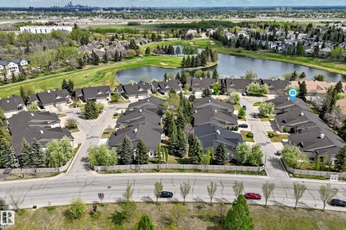 Aerial view showcasing a residential community situated alongside a large body of water and a golf course - 29 929 Picard Drive, Edmonton, AB - Outdoor With Body Of Water With View